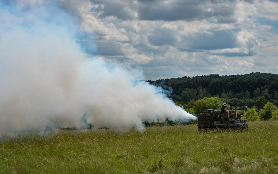 A Project Origin robotic combat vehicle blows artificial smoke for cover at the Joint Multinational Readiness Center in Hohenfels, Germany, June 8, 2022. Project Origin unmanned ground vehicles are designed to support infantry maneuvers by providing a variety of weapons and sensor attachments that can augment ground troop movements.