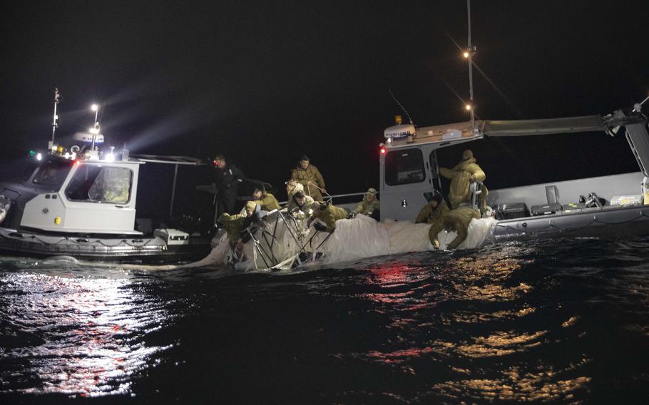 Sailors assigned to Explosive Ordnance Disposal Group 2 recover portions of a Chinese surveillance balloon off the coast of Myrtle Beach, S.C., on Feb. 5, 2023.