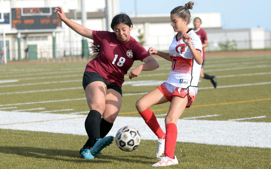 Matthew C. Perry's Markeean Lutz and E.J. King's Savannah Hays tangle for the ball during Friday's DODEA-Japan girls soccer match. The Cobras won 1-0.