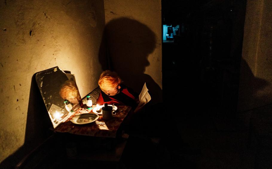 A woman reads a book underground as war rages on above ground in Lysychansk, Ukraine, Monday June 13, 2022.