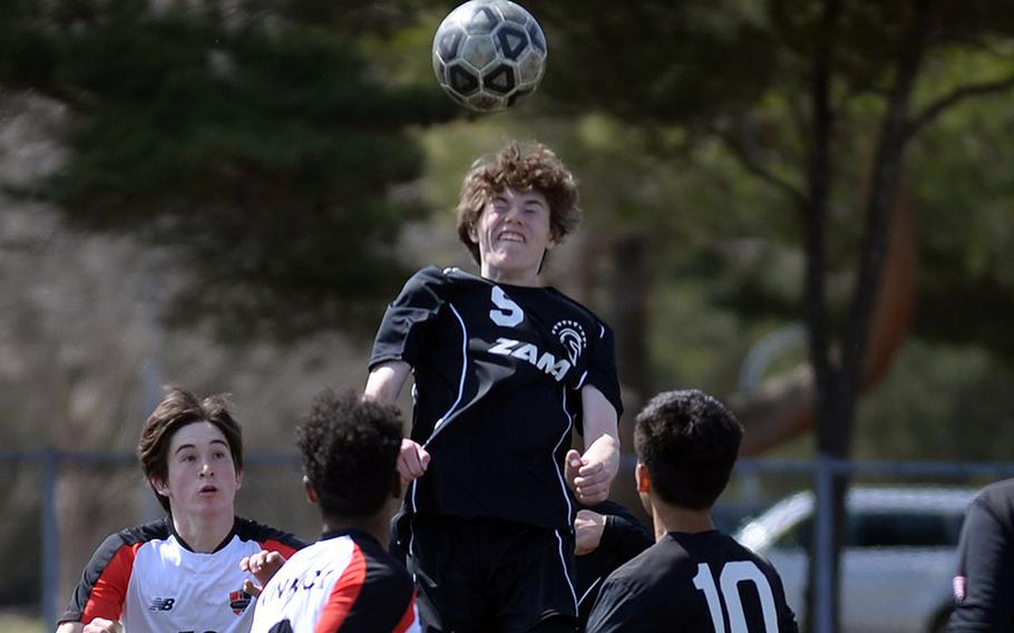 Zama's Tyler Deiwert skies to head the ball against Nile C. Kinnick during Saturday's DODEA-Japan soccer match. Deiwert scored the tying goal as the teams played to a 1-1 draw. It was the Red Devils' first result other than a win in almost three years.