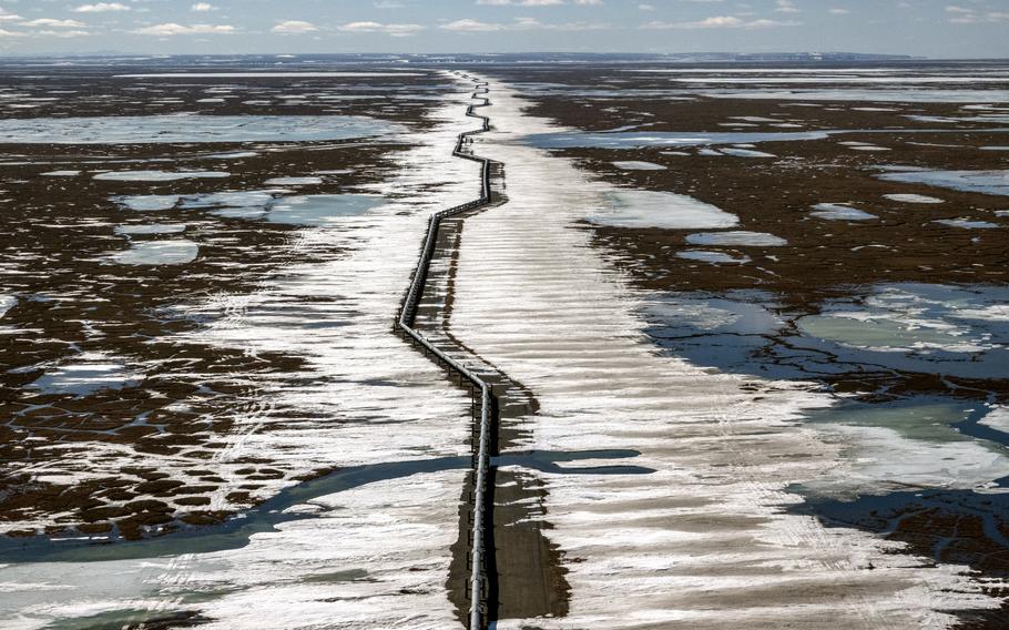An oil pipeline stretches across the landscape outside Prudhoe Bay in Alaska's North Slope Borough in 2019.