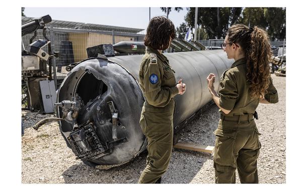 Israeli soldiers near one of the Iranian ballistic missiles that Israel intercepted last weekend. (MUST CREDIT: Heidi Levine for The Washington Post)