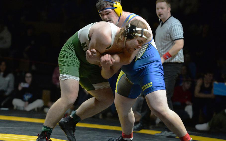 Declan Newsom of Naples and Wiesbaden’s John Ruland grapple in the 285-pound final at the DODEA-Europe wrestling championships, in Wiesbaden, Germany, Feb. 11, 2023. Ruland won the heavyweight crown.