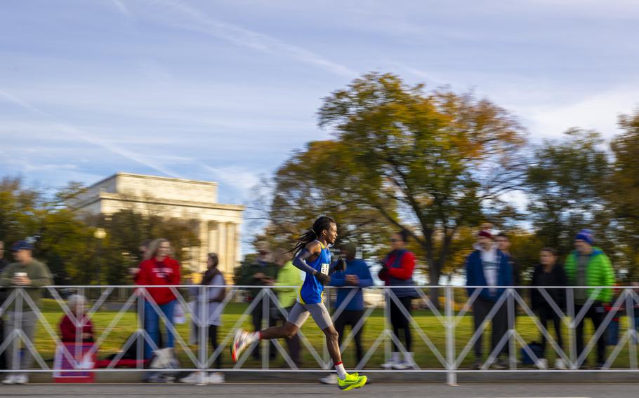 A runner passes the Lincoln Memorial
