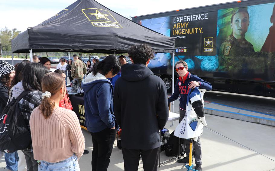 Sgt. Sagen Maddalena from the U.S. Army Marksmanship Unit shows her equipment to students from Patriot High School, Jurupa Valley, Calif., on Jan. 11, 2023. The USAMU regularly conducts marksmanship clinics, demonstrations and public appearances for civilians throughout the country.