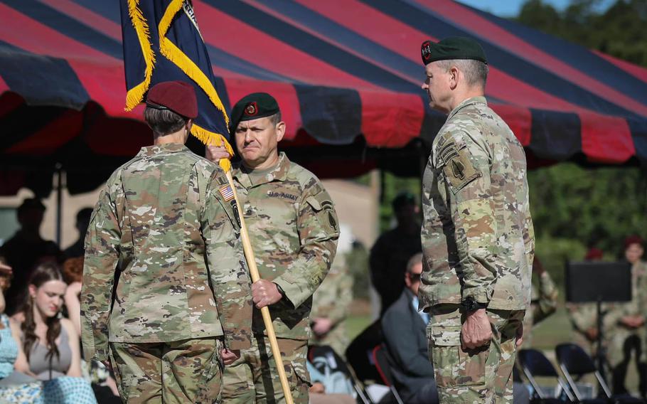 Command Sgt. Maj. Michael Weimer passes on his role at Army Special Operations Command to Command Sgt. Maj. JoAnn Naumann during a ceremony at Fort Bragg, N.C., May 1, 2023. 