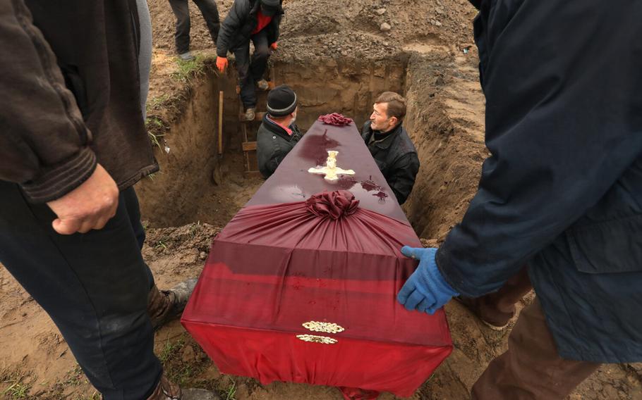 Three members of the Ostrovskii family including Viktorya , age 51, Anatoli, age 75, and Vyacheslav, age 32, were buried together in a single grave at the Bucha cemetery on April 22, 2022. The three were shot and killed by Russians on March 7, as they tried to flee Bucha, Ukraine in their car according to a family friend who was there to oversee their burial. 