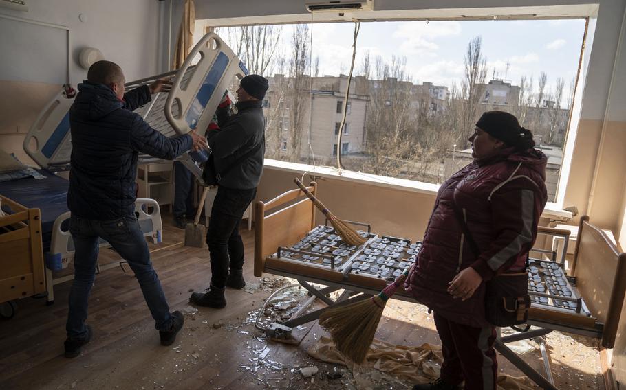Volunteers and staff clean up the destruction left after an attack on a hospital in the key battlefield area of Mykolaiv, Ukraine. 