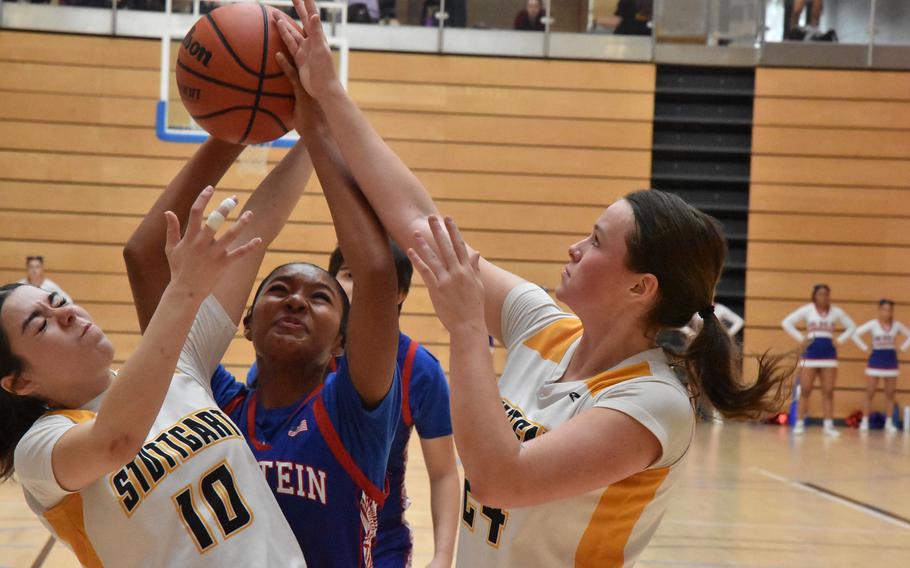 Stuttgart's Mia Snyder, from left, Ramstein's Feliciana Davis and Stuttgart's Ella Kirk battle for a rebound in Ramstein's victory over Stuttgart in pool play at the DODEA European Division I Basketball Championships on Thursday, Feb. 15, 2024, in Wiesbaden, Germany.

Kent Harris/Stars and Stripes