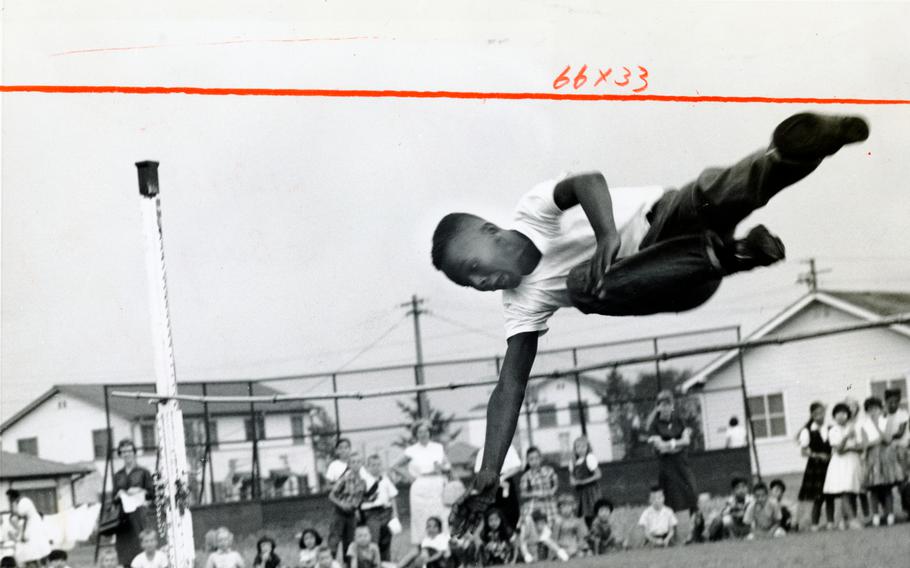 Wilson Lusk easily clears the 4-foot hurdle in the high jump competition at the Narimasu Elementary School Junior Olympics. Some 156 students participated in the events viewed by about 600 spectators. 