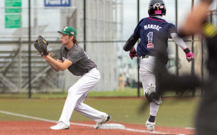 Kubasaki first baseman Jacy Fisk awaits the throw as Kadena's Waioni Mandac races down the line.
