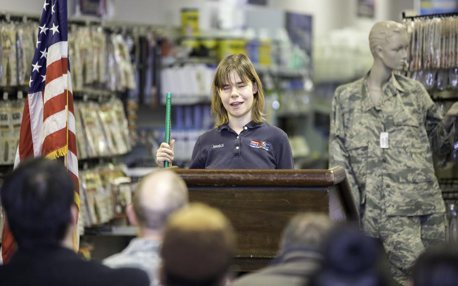 Jessica Brasseal, a graduate of Blind Industries and Services of Maryland’s (BISM) Ability One training and rehabilitation programs for the blind and an employee of BISM’s Base Supply Center on Joint Base Anacostia-Bolling (JBAB), speaks to an assembly of the store’s customers during a ceremony recognizing BISM’s 20-year relationship with the base.