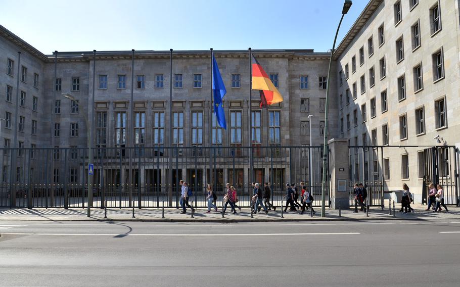 Students walk past the German Federal Finance Ministry building in Berlin. The ministry issued a new directive this week that bans its tax offices from seizing the military pay of U.S. personnel stationed in the country.