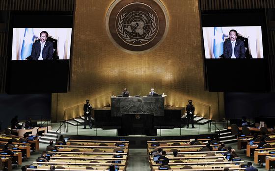 Somalia's President Mohamed Abdullahi Mohamed Farmajo is seen on a video screen as he addresses the 76th Session of the United Nations General Assembly remotely, Tuesday, Sept. 21, 2021, at U.N. headquarters. (Spencer Platt/Pool Photo via AP)
