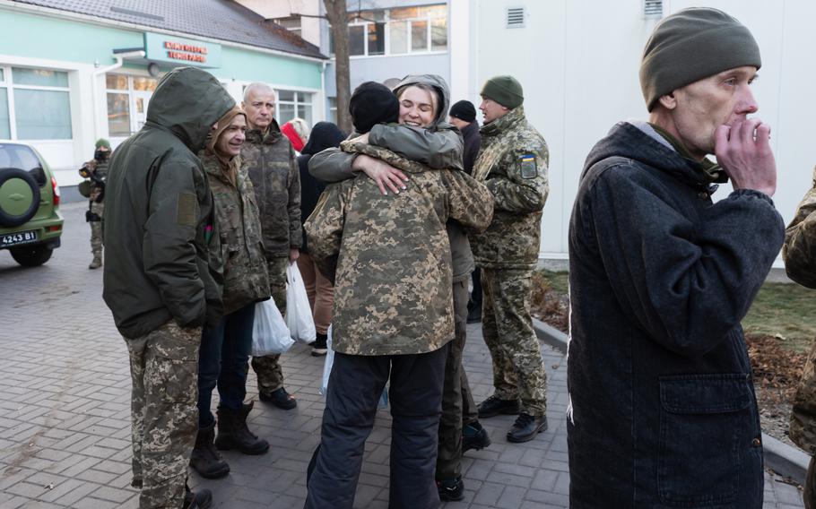 Ukrainian soldiers hug as they meet after being released in a prisoner exchange Tuesday.