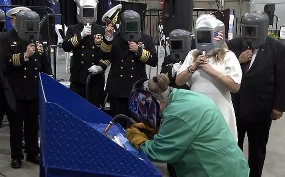 Navy Secretary Carlos Del Toro, far right, admirals and guests watch the symbolic welding of the first plate of the keel of the frigate USS Constellation on April 12, 2024, at the Fincantieri shipyard in Wisconsin.