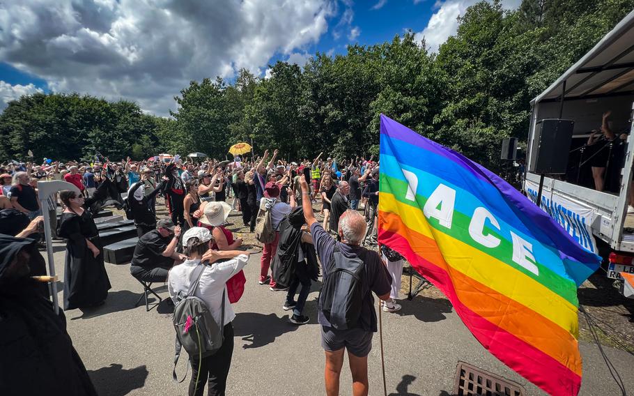 Protesters listen to anti-war songs during a “Dance of the Dead” protest in Ramstein-Miesenbach, Germany, June 25, 2022. The event was organized by the “Stop Air Base Ramstein” campaign.