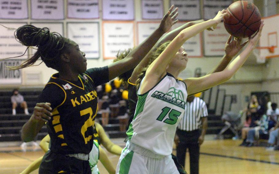 Kubasaki's Brynn Murray grabs a rebound away from Kadena's Sincere Chambers and Destiny Richardson during Thursday's Okinawa basketball game. The Panthers won 43-8.