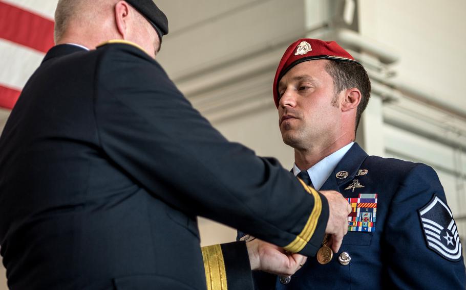 Brig. Gen. Hal Lamberton, left, the adjutant general for the Commonwealth of Kentucky, pins the Airman’s Medal to the uniform of Master Sgt. Daniel Keller, a combat controller in the 123rd Special Tactics Squadron, during a ceremony at the Kentucky Air National Guard Base in Louisville, Ky., June 12, 2021. 