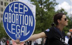 FILE - Abortion-rights demonstrator holds a sign during a rally on May 14, 2022, in Chattanooga, Tenn. In legislative sessions in 2023, GOP-controlled states have been moving to tighten abortion restrictions and those dominated by Democrats have continued to codify protections to abortion access. (AP Photo/Ben Margot, File)