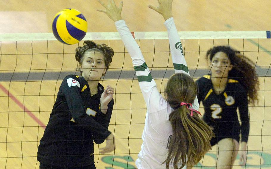 Kadena’s Marina Sawyer drives a spike past Kubasaki’s Alice Baron during Tuesday’s Okinawa volleyball match. The Dragons won in straight sets.