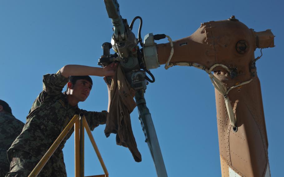 An Afghan army air corps soldier cleans the rear rotor of an Mi-17 helicopter during aircraft maintenance in Afghanistan in 2012. The forces have since acquired U.S.-made Black Hawk helicopters. Afghan maintainers said theyve been practicing remote assistance via video calls for two months, as U.S-funded maintenance contractors prepare to leave the country. 