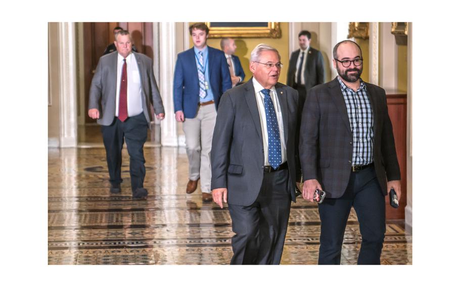 Sen. Bob Menendez, D-N.J., at left in foreground, heads to the Senate Chamber on Thursday, Sept. 21, 2023.