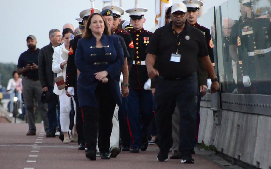 U.S. charge d'affaires to the Netherlands, Marja Verloop, front left, walks alongside Association of the U.S. Army European region president, Tony Williams, on the Oversteek Bridge in Nijmegen, the Netherlands, Aug. 13, 2021, during the Sunset March. 