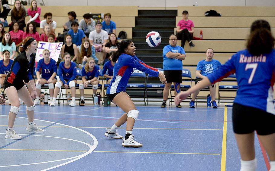 Ramstein's Jasmine Jones, center, bumps the ball while teammates Lily Rethage, left, and Kellani Gonzalez watch during pool-play action at the DODEA European volleyball championships Friday at Ramstein High School on Ramstein Air Base, Germany.