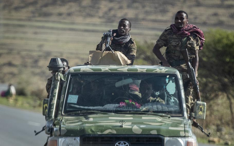 In this Saturday, May 8, 2021 file photo, Ethiopian government soldiers ride in the back of a truck on a road near Agula, north of Mekele, in the Tigray region of northern Ethiopia.