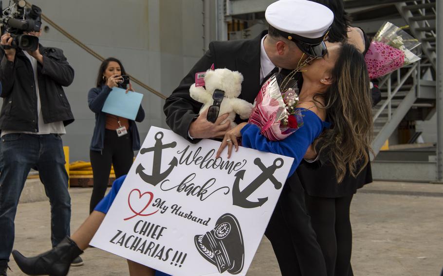 Chief Aviation Electrician’s Mate Ezekial Zacharias, assigned to amphibious assault carrier USS Tripoli (LHA 7), dips his wife for a kiss upon Tripoli’s return to homeport, Tuesday, Nov. 29, 2022. Tripoli returned to Naval Base San Diego following its initial deployment to the U.S. 3rd and 7th Fleets in support of a free and open Indo-Pacific.