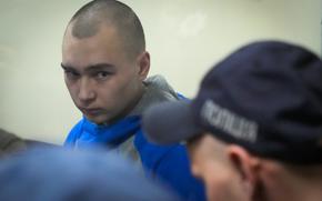 Russian army Sergeant Vadim Shishimarin, 21, is seen behind a glass during a court hearing in Kyiv, Ukraine, Wednesday, May 18, 2022. The Russian soldier has gone on trial in Ukraine for the killing of an unarmed civilian. The case that opened in Kyiv marked the first time a member of the Russian military has been prosecuted for a war crime since Russia invaded Ukraine 11 weeks ago. (AP Photo/Efrem Lukatsky)