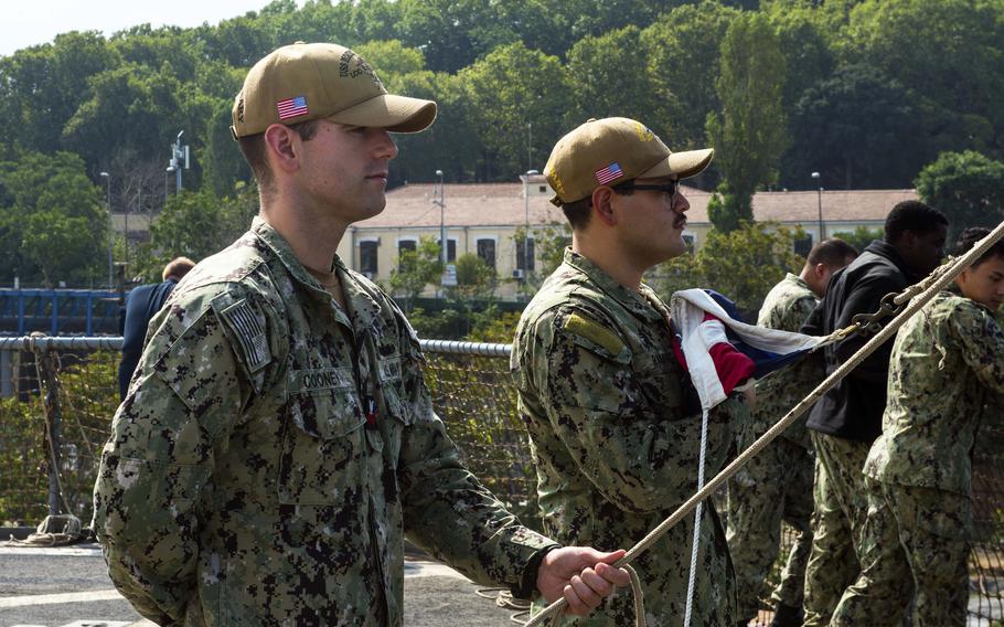 Petty Officer 1st Class Donald Cooney and Petty Officer 3rd Class Alexander Ramirez prepare to raise the ensign aboard the USS Mount Whitney in Istanbul on Aug. 18, 2023. Mount Whitney, the 6th Fleet flagship, homeported in Gaeta, Italy, left Istanbul on Monday.