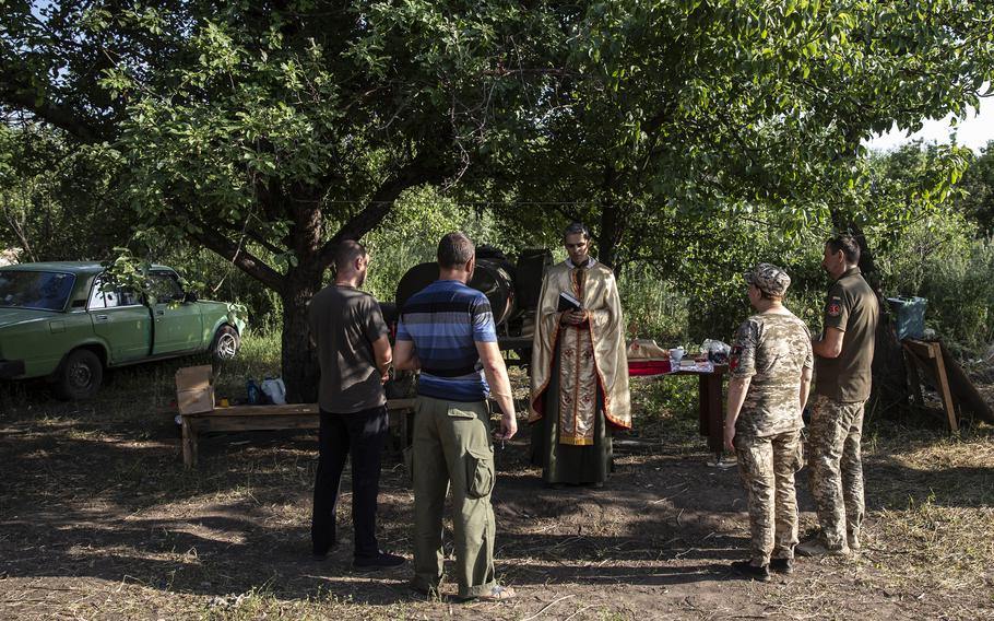 Father Vitalii Kester celebrates Mass with soldiers in the Donbas region. 