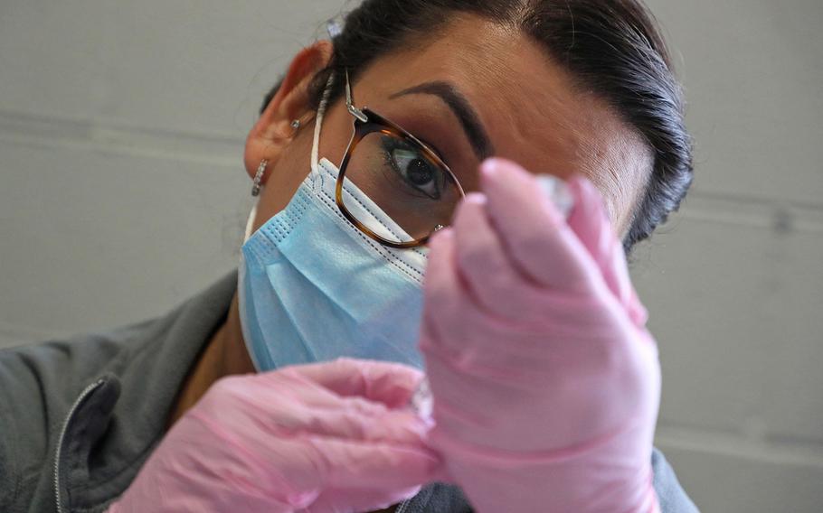 Lisa Leon, a patient service coordinator, draws up a syringe full of the Pfizer COVID-19 vaccine at the Esperanza Health Centers vaccination clinic on Tuesday, Dec. 21, 2021, in Chicago. 