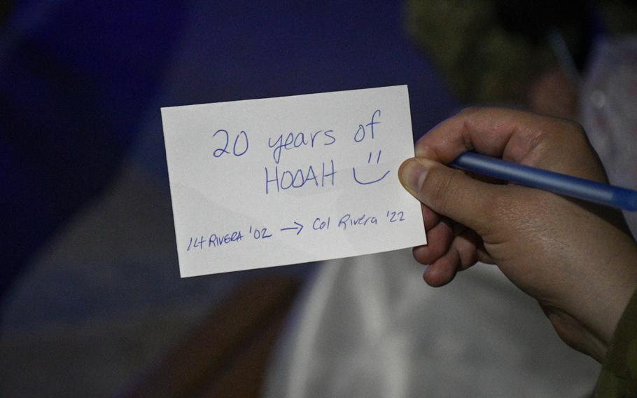 U.S. Air Force Col. Amy Rivera, director of staff at the 379th Air Expeditionary Wing, shows a card she wrote on April 22, 2022, to commemorate how she deployed to Al Udeid Air Base, Qatar, two decades apart.  