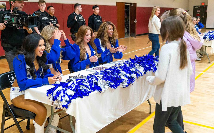 Dallas Cowboys Cheerleaders sign autographs at John W. Collier Fitness Center at Camp Humphreys, South Korea, Feb. 23, 2024.