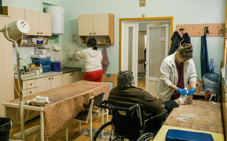 Nurses change a patient’s dressing Thursday at Kherson City Clinical Hospital. 