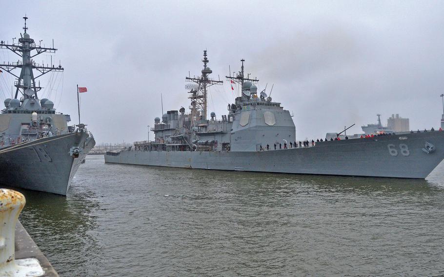 The Ticonderoga-class guided-missile cruiser USS Anzio (CG 68), right, departs Norfolk Naval Station in March 2015. To pay for the ships and unmanned vessels the Navy hopes to build over the next few years, it wants to decommission seven cruisers.