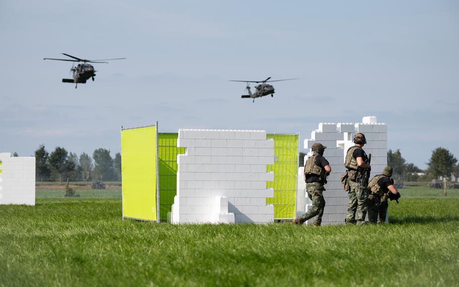 Dutch soldiers prepare to battle U.S. and Dutch troops arriving by helicopter during an air assault demonstration in Eerde, Netherlands, on Tuesday, Sept. 17, 2024.