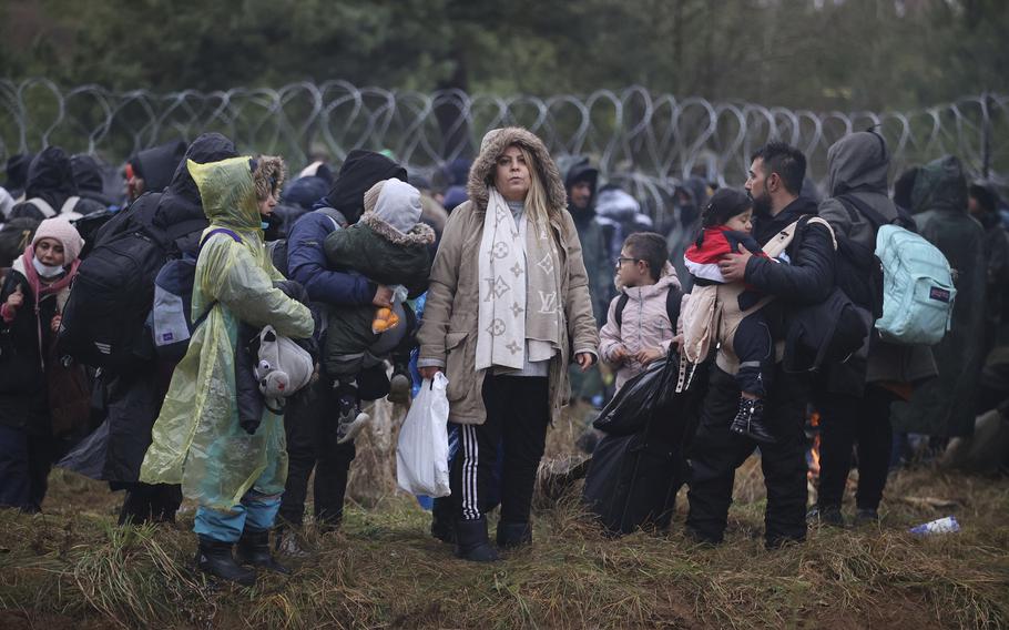 Migrants from the Middle East and elsewhere gather at the Belarus-Poland border near Grodno, Belarus, Monday, Nov. 8, 2021. Poland increased security at its border with Belarus, on the European Union’s eastern border, after a large group of migrants in Belarus appeared to be congregating at a crossing point, officials said Monday. The development appeared to signal an escalation of a crisis that has being going on for months in which the autocratic regime of Belarus has encouraged migrants from the Middle East and elsewhere to illegally enter the European Union, at first through Lithuania and Latvia and now primarily through Poland.