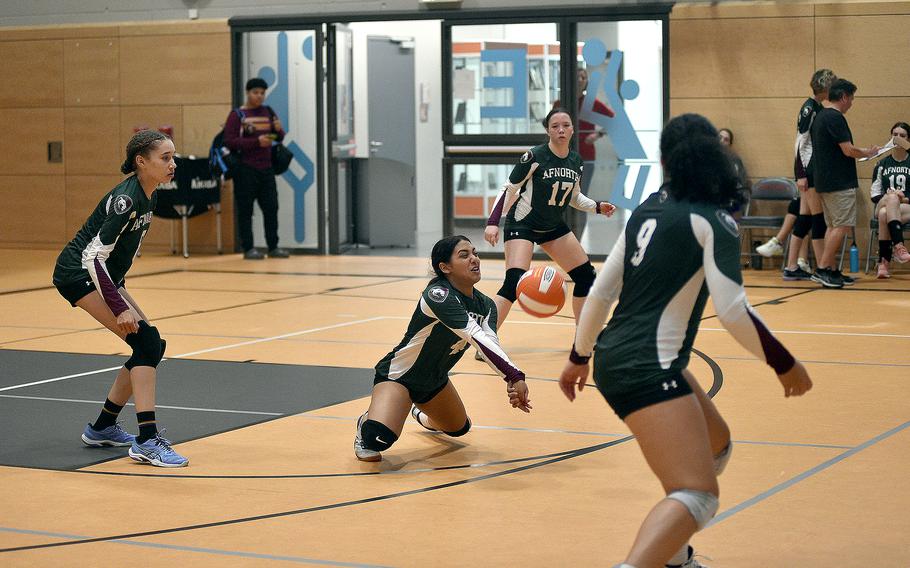AFNORTH junior Selah Skariah goes down for a dig during a scrimmage on Sept. 1, 2023, at Spangdahlem High School in Spangdahlem, Germany. Watching are teammates Rowan Moreno, left; Isabella Guest, background center; and Sophia Mier, right.