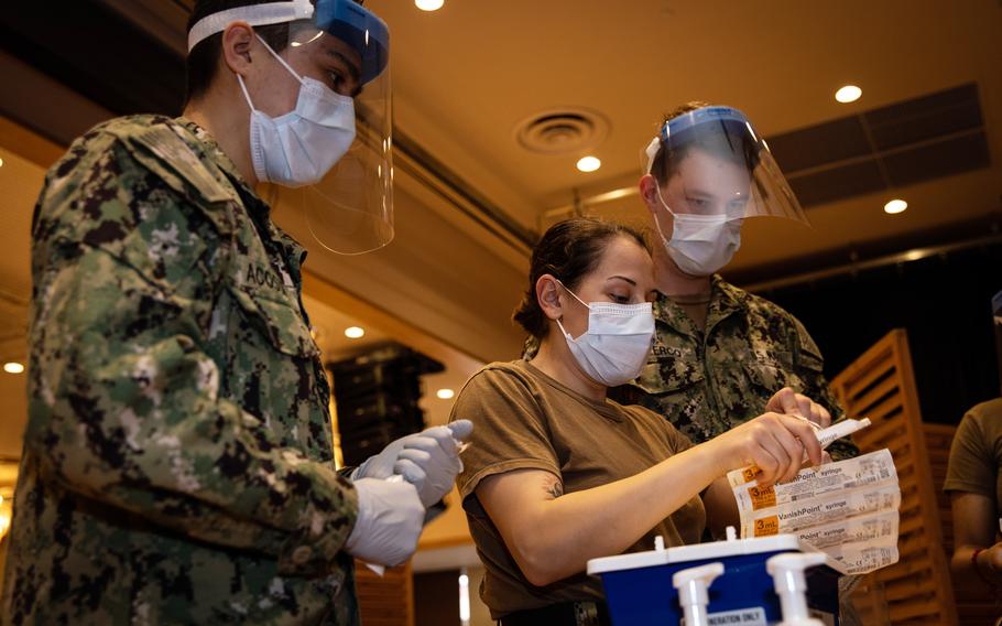 Staff from U.S. Naval Hospital Okinawa prepare to administer COVID-19 vaccines earlier this year at Camp Hansen.