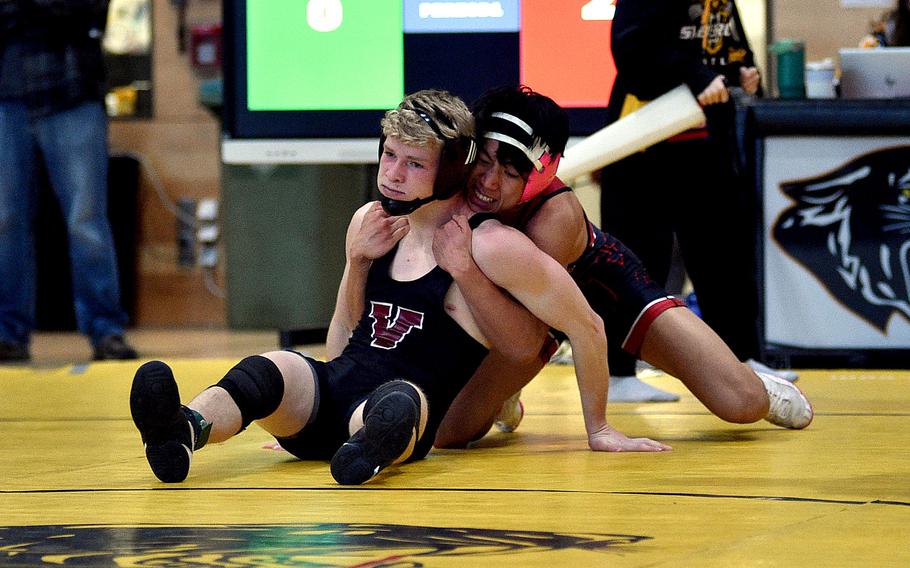 Kaiserslautern's Joshua Kim grips Vilseck's Christopher Wissemann in the 126-pound final during a DODEA wrestling sectional meet on Feb. 3, 2024, at Stuttgart High School in Stuttgart, Germany.