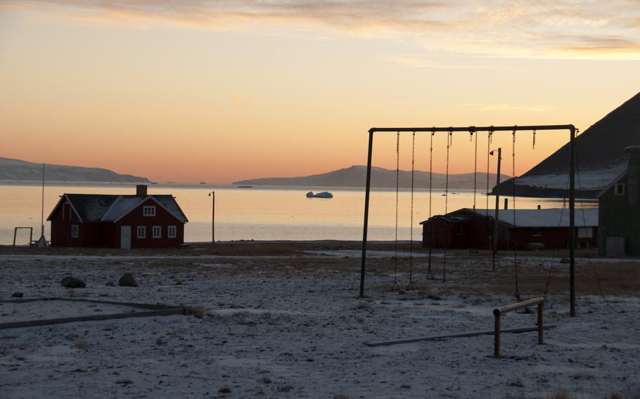 Swingsets and icebergs; the view from the abandoned village near Thule Air Base. Deterioration is slow in the dry cold.