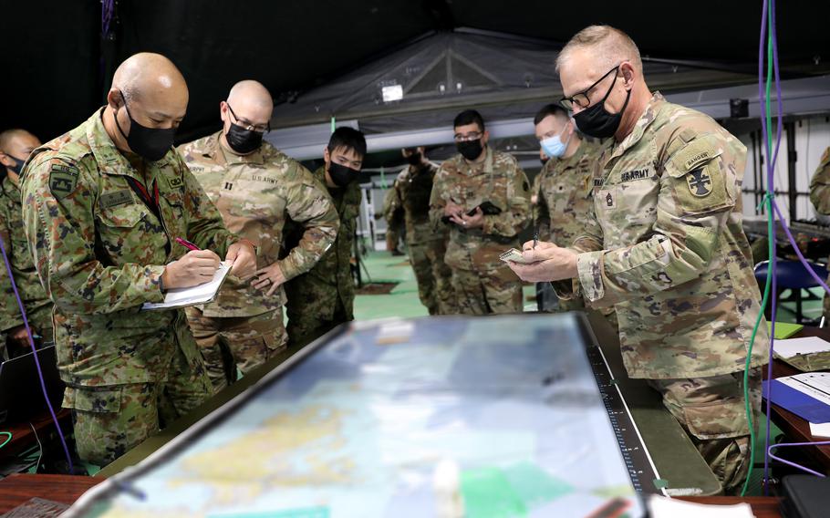 U.S. soldiers from the 206th Digital Liaison Detachment, 412th Theatre Engineer Command and members of the Japan Ground Self-Defense Force prepare for the Yama Sakura exercise at Camp Kengun, Japan, Dec. 2, 2022.