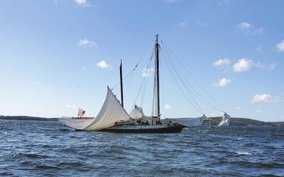 A boat with a broken mast at sea in Maine.