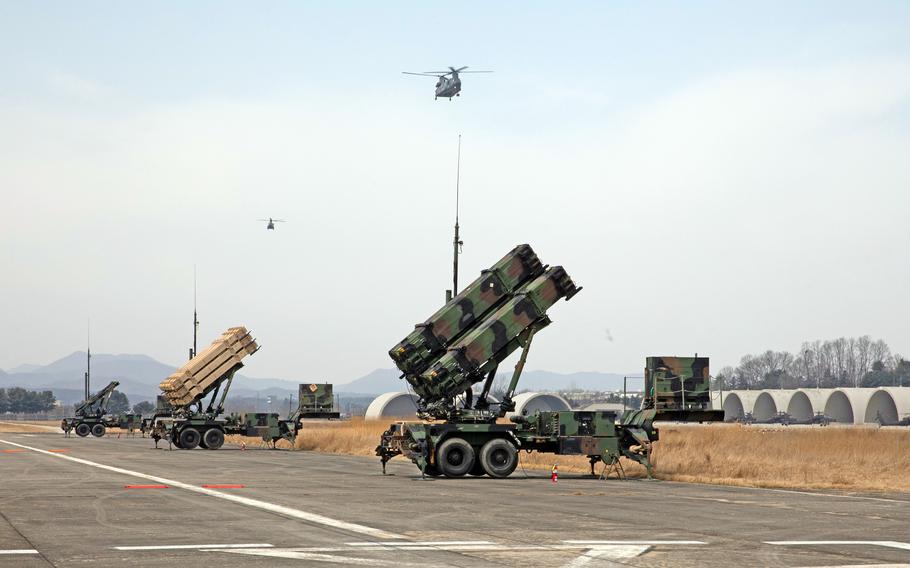 U.S. Army Patriot missile launchers are positioned on a runway.