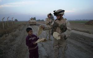 Hed: Giving, 2004

Hora Al Bosh, Iraq, Dec. 30, 2004: An Iraqi boy gives freshly baked flatbread to Spc. Acisclo Melendez of Company A, 1st Battalion, 69th Infantry. 

As a regular part of their patrols in the areas around Taji, the National Guard soldiers of the 1st Battalion, 69th Infantry Regiment have been handing out blankets and toys to children and families in an effort to “win the hearts and minds” of people who could help bring stability to the region. Today, they received a gift in return. 

Read more at: https://www.stripes.com/news/2005-01-03/toys-and-tea-the-spirit-of-giving-1915707.html1

META TAGS: Wars on Terror; Operation Iraqi Freedom; U.S. Army
